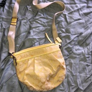 Yellow monogrammed Coach cross body bag